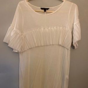 Ivory tee with ruffle detail.